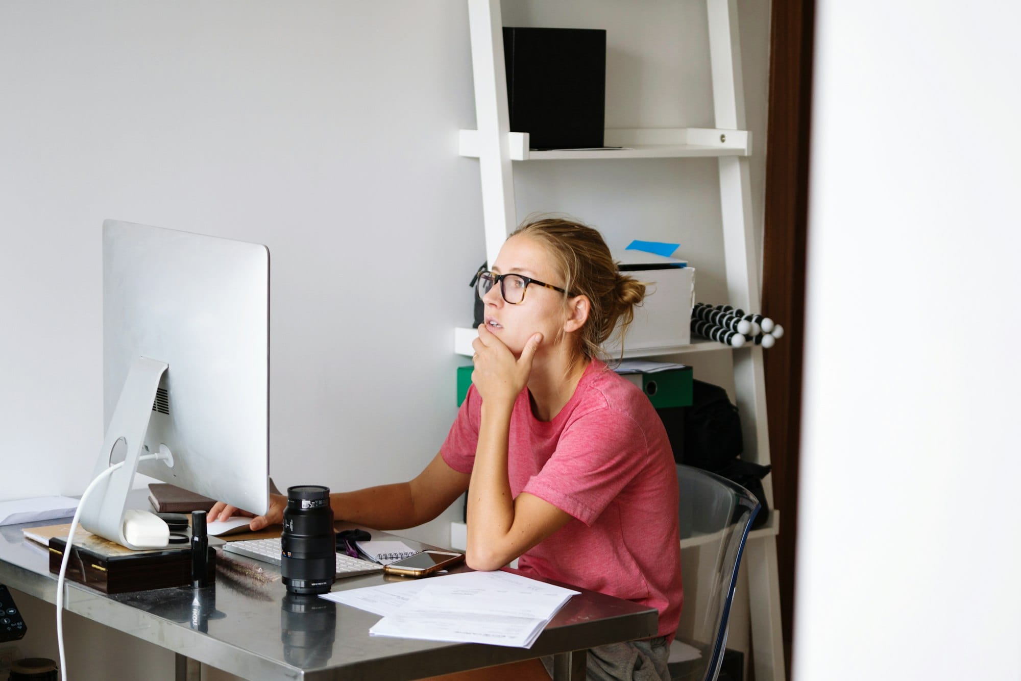 Female photographer working at home on a desktop computer