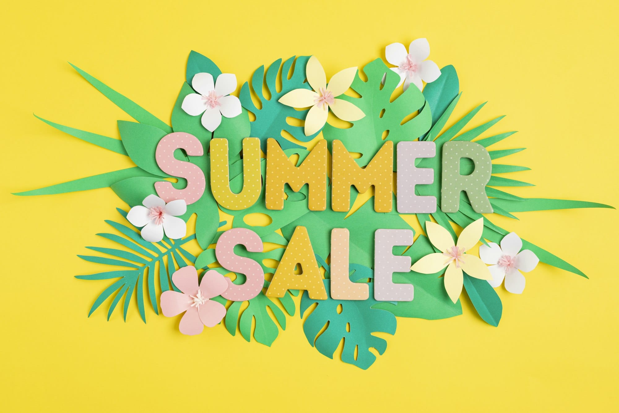 Word Sale over tropical paper cut leaves background. Summer sale, online deals, discounts idea