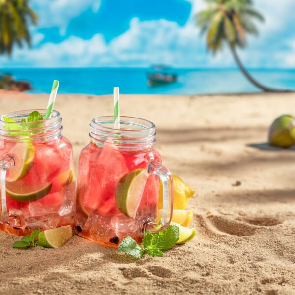 Lemonade with watermelon on beach at ocean in summer.